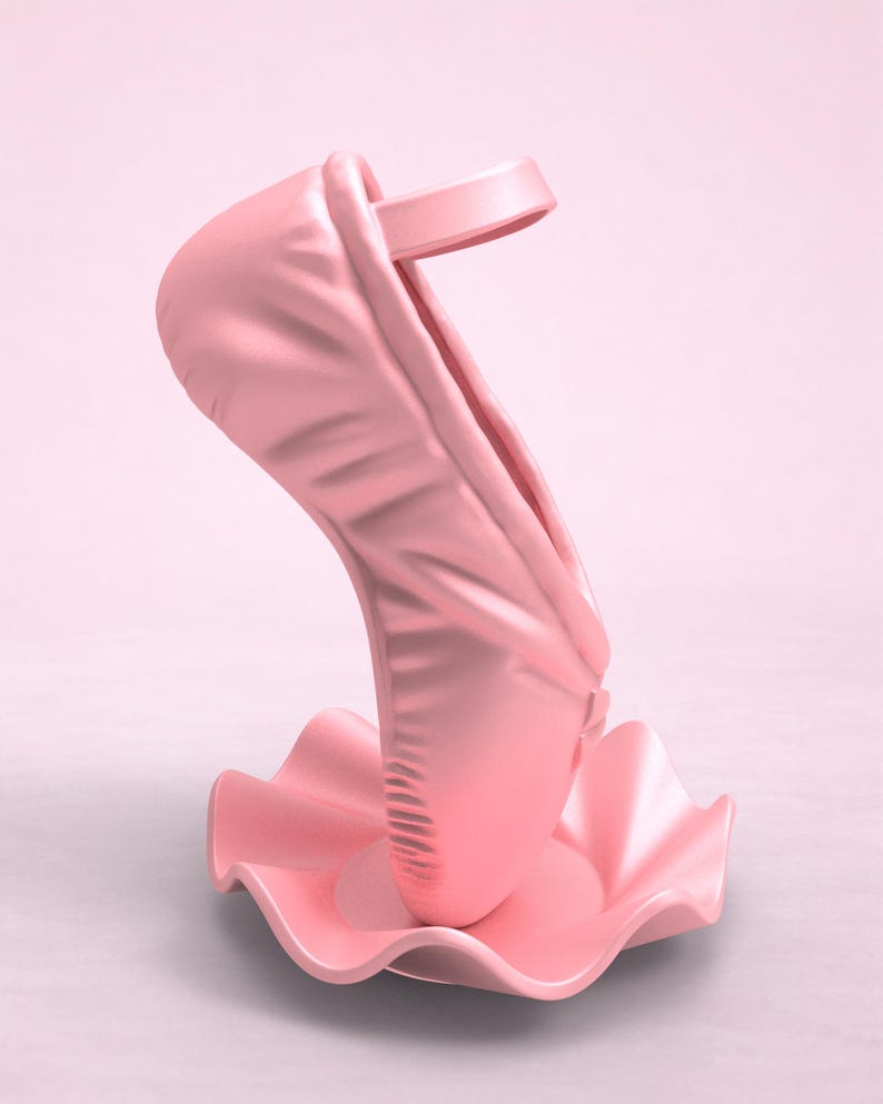 May include: A light pink ballet slipper sculpture standing upright on a matching pink, circular, ruffled base. The shoe features a smooth, matte finish with a single strap across the top opening, presented in a monochromatic design.