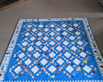 Patchwork Quilt with blue, white and multicoloured diamond pattern