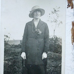 Martha Elegant Women in Car Coat Postal, Fotografía en blanco y negro Postal de mujeres vestidas, guantes blancos, abrigo de coche con sombrero, broche de flores