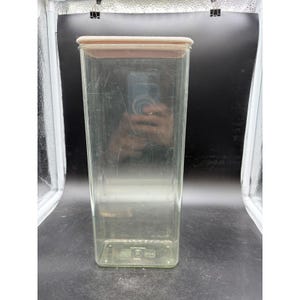 May include: A set of three ceramic mugs with a speckled, matte finish. The mugs are in shades of cream, light brown, and dark brown. Each mug has a simple, minimalist design and a rounded handle.