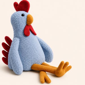 May include: A plush rooster toy featuring a textured light blue body, a bright red comb and wattle, and a dark red tail. The rooster has a mustard yellow beak and long, mustard yellow legs with three-toed feet, all crafted from soft fabric.