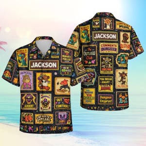 May include: Black button-down shirt with a collage of cartoon-like images and text. The shirt features the name "JACKSON" prominently displayed. The design includes various characters and phrases on a dark background.