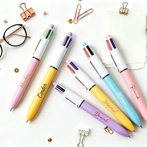 May include: A white ceramic mug with a black handle and the text "But First, Coffee" in a bold, black font. The mug is set against a blurred background, suggesting a cozy setting.