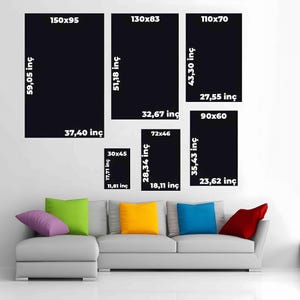 May include: A light gray sectional sofa with purple, lime green, yellow, blue, and red throw pillows. Above the sofa are six black rectangular wall art frames with white text labels indicating dimensions in centimeters and inches.