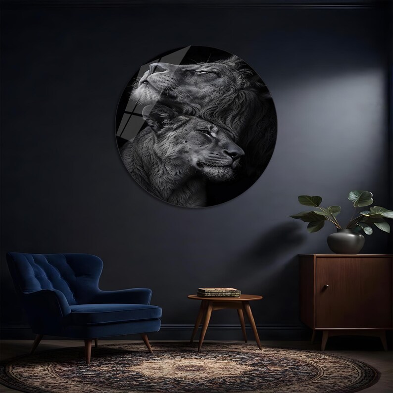 May include: A circular wall art piece featuring a black and white photographic portrait of a lion and a lioness resting their heads together. The image captures the detailed texture of their fur and manes in a high-contrast monochromatic style.
