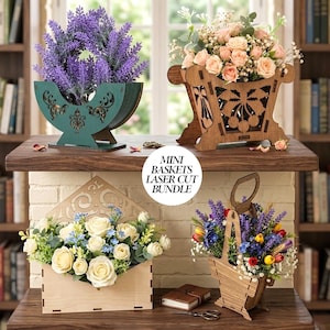 May include: Four laser-cut wooden baskets, each holding flowers. Designs include a teal half-moon, a rectangular box, and a handled basket. The text "MINI BASKETS LASER CUT BUNDLE" is in a white circle. The baskets are displayed on a wooden surface.