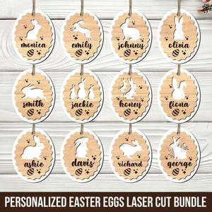 Puede incluir: Adornos de huevos de Pascua de madera con diseños de conejitos cortados con láser y nombres. Cada huevo ovalado tiene un borde festoneado y una cuerda para colgar. Los nombres incluyen Monica, Emily, Johnny, Olivia, Smith, Jackie, Honey, Fiona, Ashie, Davis, Richard y George.