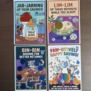 May include: Four rectangular savings challenge cards featuring cartoon cats. The cards display the text Jar-Jarring Up Your Savings, Lim-Lim Up Those Deposits While You Sleep, Bin-Bin Digging For Better Returns, and Paw-Sitively Happy Saving with holographic scratch-off circles.