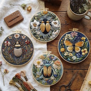May include: Four embroidered insect art pieces in wooden hoops. Each features a different insect design, including a beetle and a butterfly, surrounded by floral embroidery. The color palette includes blues, greens, and creams, with detailed stitching.