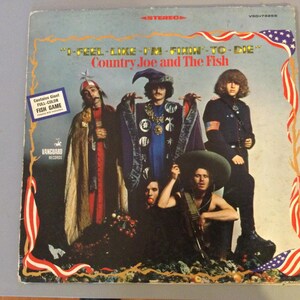 May include: A set of three ceramic mugs with a speckled, matte finish. The mugs are in shades of cream, light gray, and dark gray. Each mug has a simple, minimalist design and a rounded handle.