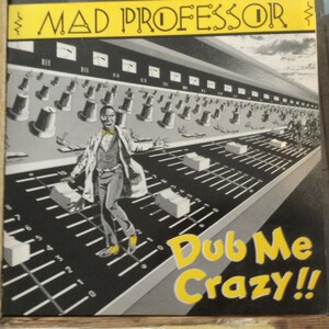 May include: Album cover art for "Mad Professor Dub Me Crazy!!" featuring a man in a lab coat and bow tie on a sound mixing board. The album title is in yellow, with a black and white illustration.