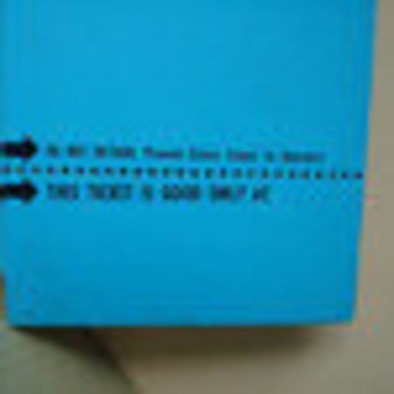 May include: A close-up of a blue ticket with the text "TO BE RETURNED, Please Send Ticket to Security" and "THIS TICKET IS GOOD ONLY ON". The ticket has a dotted line and arrows.