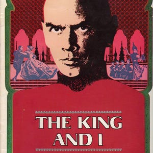 May include: Vintage movie poster for "The King and I." The poster features a stern-faced man with a partially shadowed face. The title is in white capital letters on a red background, with a decorative border. The background includes illustrations of dancers.