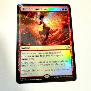May include: A Magic: The Gathering card titled "Flare of Duplication." The card features a fiery, abstract illustration with red and orange hues. Text details the spell's effects, including copying instant or sorcery spells. The card is from the MH3 set.
