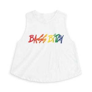 May include: White sleeveless crop top with the text "BASS BITCH" in rainbow colors. The text is in a handwritten style. The top has a rounded neckline and a slightly flared bottom hem.