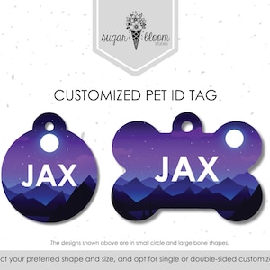 May include: Customized pet ID tags in a circle and bone shape. The tags feature a purple and blue mountain scene with the name "JAX" in white. The tags have a hole for attachment.