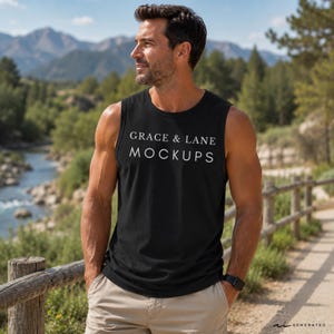 May include: A black sleeveless tank top featuring the white text GRACE & LANE MOCKUPS printed on the chest. The garment has a round neckline and wide arm openings, paired with light beige shorts and a black digital watch on the left wrist.