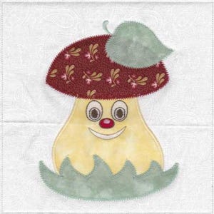 May include: A fabric applique of a mushroom character on a white background. The mushroom has a dark red cap with a floral pattern, a light yellow stem with a smiling face, a small red nose, and a light green leaf and base trim.