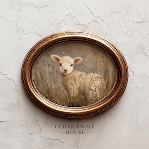 May include: An oval framed print depicting a lamb in long grass. The lamb is white with a light brown face and ears. The gold frame has a detailed pattern. The text "CEDAR PRINT HOUSE" is at the bottom of the print.