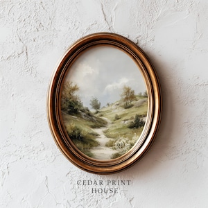 May include: Oval framed landscape art print featuring a serene path winding through rolling green hills with sparse trees under a cloudy sky. The frame is a warm, golden color. The text "CEDAR PRINT HOUSE" is at the bottom.