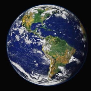 May include: A vibrant image of Earth, showcasing the continents and oceans. The planet is depicted with swirling white clouds, lush green landmasses, and vast blue oceans. The image is set against a black background, highlighting the Earth's spherical shape.