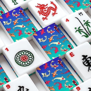 May include: A collection of white Mahjong tiles with various symbols and numbers. The tiles are arranged in a grid pattern, with a blue and teal koi fish design on the back of each tile. Some tiles feature red dragons, bamboo, and other symbols.