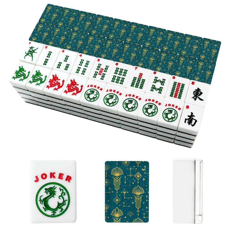 May include: A complete Mahjong set with white tiles featuring green and red dragon designs, along with the word "JOKER". The set includes a teal and gold patterned card deck. The tiles are stacked, ready for play.