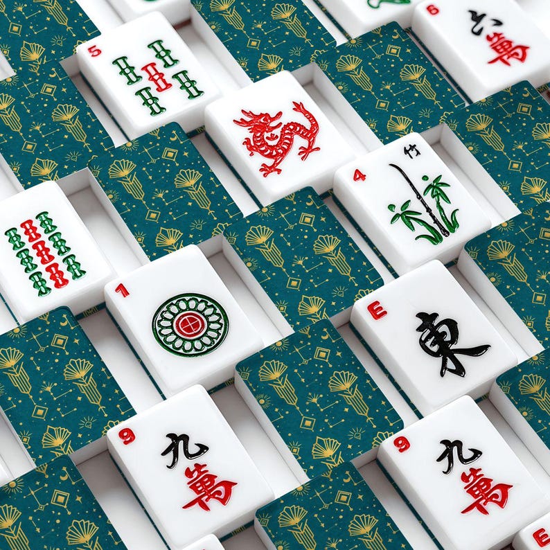May include: A set of white Mahjong tiles with red, green, and black symbols and characters. The tiles are arranged in rows with teal and gold patterned card backing. The tiles feature various symbols, numbers, and Chinese characters.