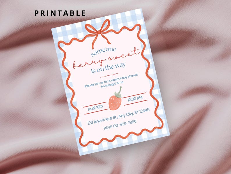 May include: A printable baby shower invitation with a light blue gingham background and a red wavy border. The text "someone berry sweet is on the way" is written in red script. A strawberry illustration is included.