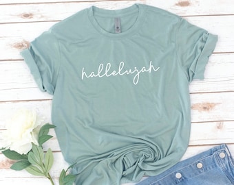 May include: A light blue t-shirt with the word "hallelujah" written in white cursive script.