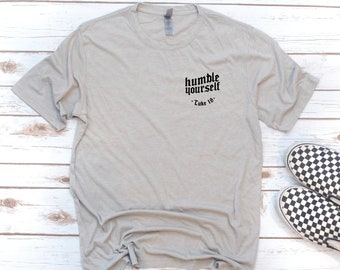 May include: A heather grey t-shirt with the text "humble yourself" in black gothic font and "Luke 18" in smaller font below.