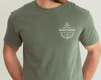 May include: A green t-shirt with a white anchor graphic and the text "HOPETIMIST anchor of my soul" and "HEB. 6:19".