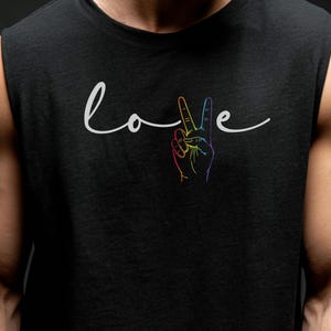 May include: Black vest top featuring the word "Love" in a cursive script, accompanied by a rainbow-coloured peace sign hand gesture. The design is centrally placed.
