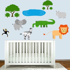 May include: A set of colorful animal wall decals featuring a zebra, lion, elephant, monkey, hippopotamus, crocodile, and two trees. The decals are on a light blue wall above a white crib.