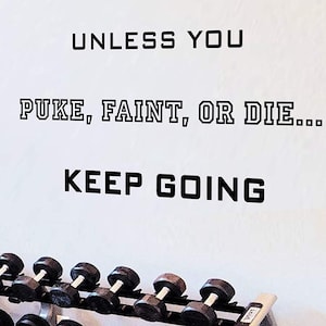 May include: A motivational quote on a white wall in a gym setting: "Unless you puke, faint, or die... keep going". A row of black dumbbells is in the foreground.