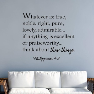 May include: A white sofa with wooden arms sits in front of a light blue wall with a black vinyl decal of a Bible verse from Philippians 4:8. The verse reads "Whatever is: true, noble, right, pure, lovely, admirable... if anything is excellent or praiseworthy... think about these things, Philippians 4:8."