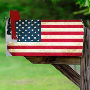 May include: A wooden mailbox with a distressed American flag design. The flag is red, white, and blue with white stars on a blue field.