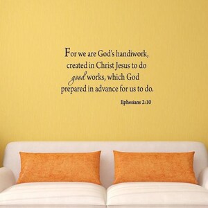 May include: A white couch with orange throw pillows in front of a yellow wall with a black and white inspirational quote that reads "For we are God's handiwork, created in Christ Jesus to do good works, which God prepared in advance for us to do. Ephesians 2:10"