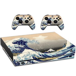 May include: A blue and white Xbox Series X console skin with a Japanese wave design. The skin features a large wave with a mountain in the background. The skin is also available for two Xbox controllers.