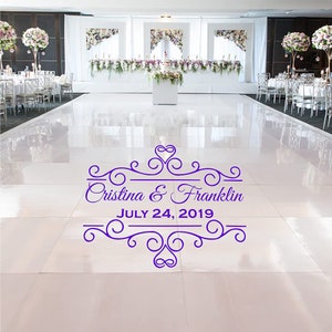May include: A white dance floor with a purple wedding announcement that reads "Cristina & Franklin JULY 24, 2019" with a decorative heart and scroll design.