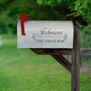 May include: White mailbox with a black vinyl decal that reads "Johnsons" with a decorative scroll design and "3295 Ticktock Road" underneath.