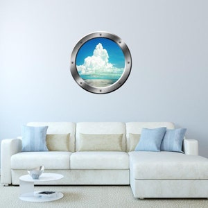 May include: A round, silver-colored porthole sticker with a view of a blue sky and white clouds over a calm ocean.