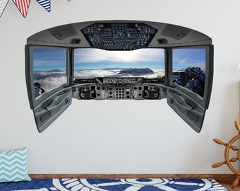 May include: A grey and black aeroplane cockpit wall decal with a view of mountains and clouds through the windows. The decal features a detailed instrument panel and control levers.