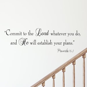 May include: A white wall with a black and white inspirational quote that reads "Commit to the Lord whatever you do, and He will establish your plans." The quote is from Proverbs 16:3. A wooden staircase is in the background.