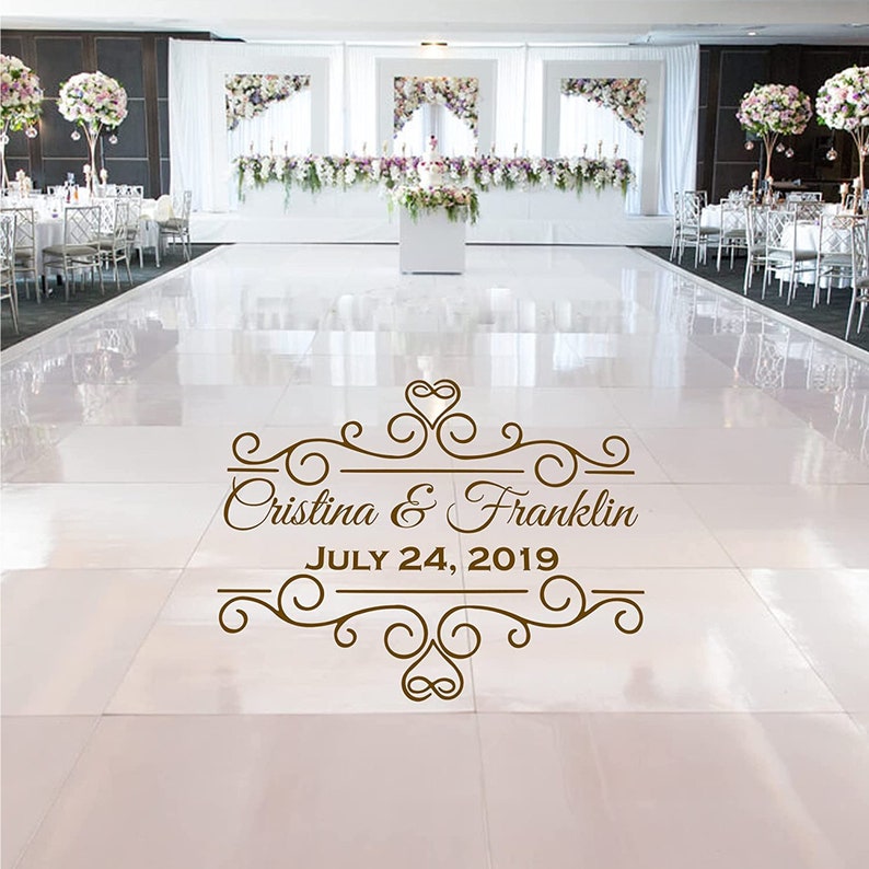 May include: A white dance floor with a brown decorative design that says "Cristina & Franklin JULY 24, 2019".
