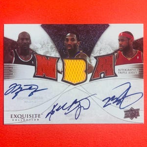 May include: A basketball trading card featuring Michael Jordan, Kobe Bryant, and LeBron James. The card has the NBA logo and the words "Autographed Triple Jerseys." The card is from the "Exquisite Collection."