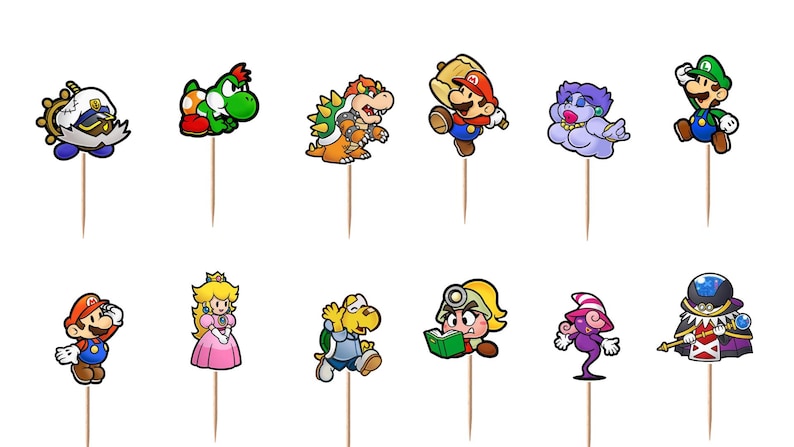 May include: A set of twelve decorative food picks featuring colorful, two-dimensional cartoon character illustrations from the Paper Mario series, including Mario, Luigi, Peach, Bowser, Yoshi, and various other figures, each attached to a thin wooden stick.