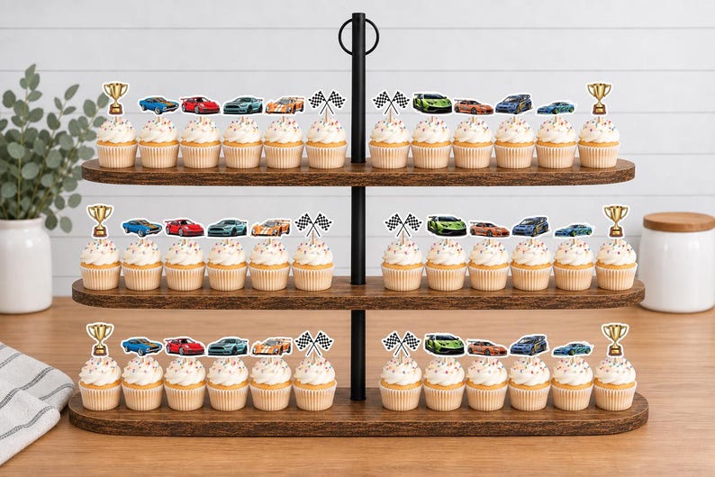 May include: A three-tiered wooden stand holding cupcakes decorated with paper toppers featuring various colorful race cars, checkered flags, and gold trophies. The cupcakes are arranged in rows on each level of the dark brown tiered display stand.