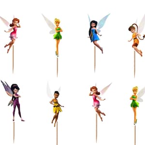 May include: A set of twelve decorative cupcake toppers featuring various fairy characters with translucent wings, each attached to a thin wooden pick. The fairies are depicted in diverse poses and colorful outfits, including shades of green, blue, pink, and purple.