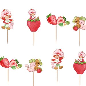 Op de afbeelding: Een set van twaalf cupcake-toppers met aquarelillustraties van een meisje met een aardbeienhoed, roze katten, bruine honden en rode aardbeien. Elke afbeelding is bevestigd aan een dunne houten prikker voor gebruik in voedsel.